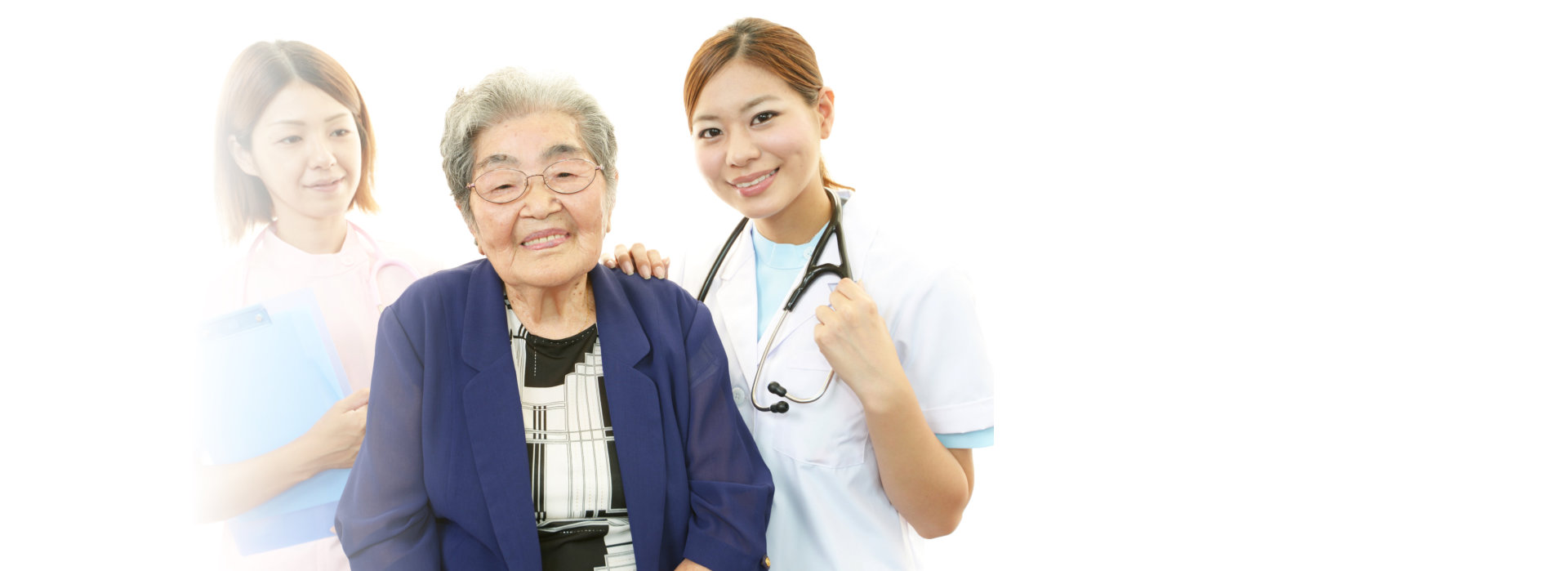 elderly woman and two medical staff smiling