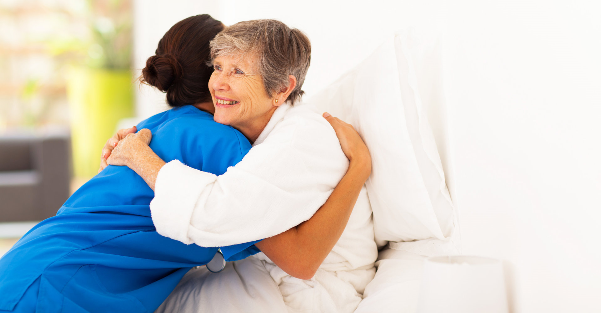 caregiver hugging patient