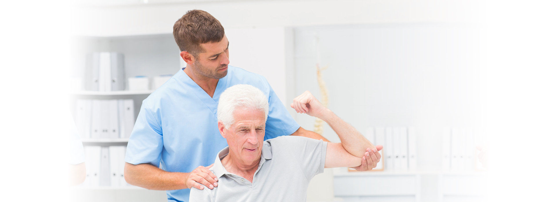 caregiver assisting patient in lifting his arm