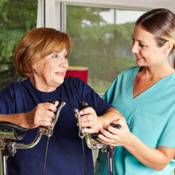 senior woman having physical therapy with her caregiver
