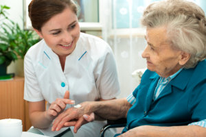 nurse assisting senior woman